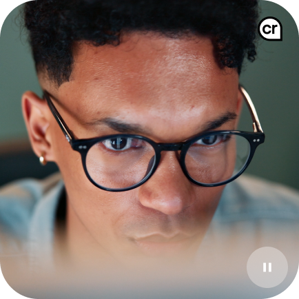 Person with glasses looking at device.